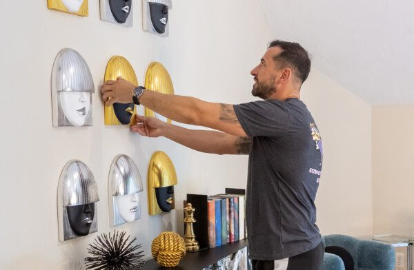 movers arranging art on a wall