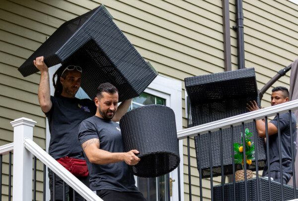Movers moving deck furniture